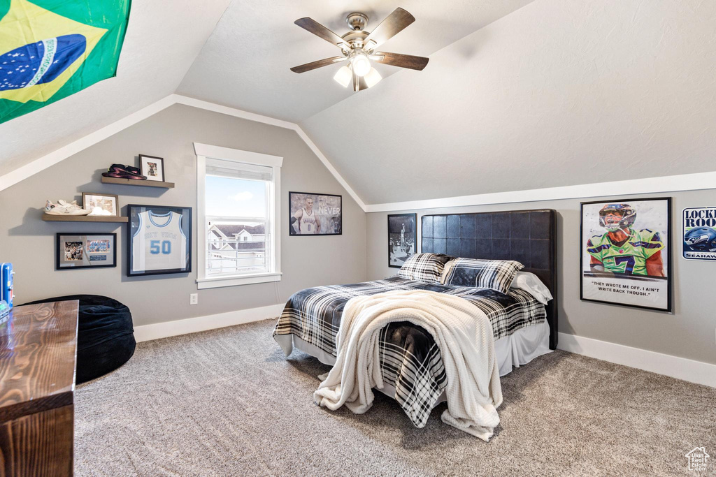 Carpeted bedroom with lofted ceiling, ceiling fan, and baseboards