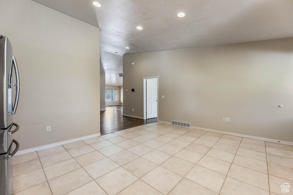 Empty room featuring recessed lighting, light tile patterned floors, and baseboards