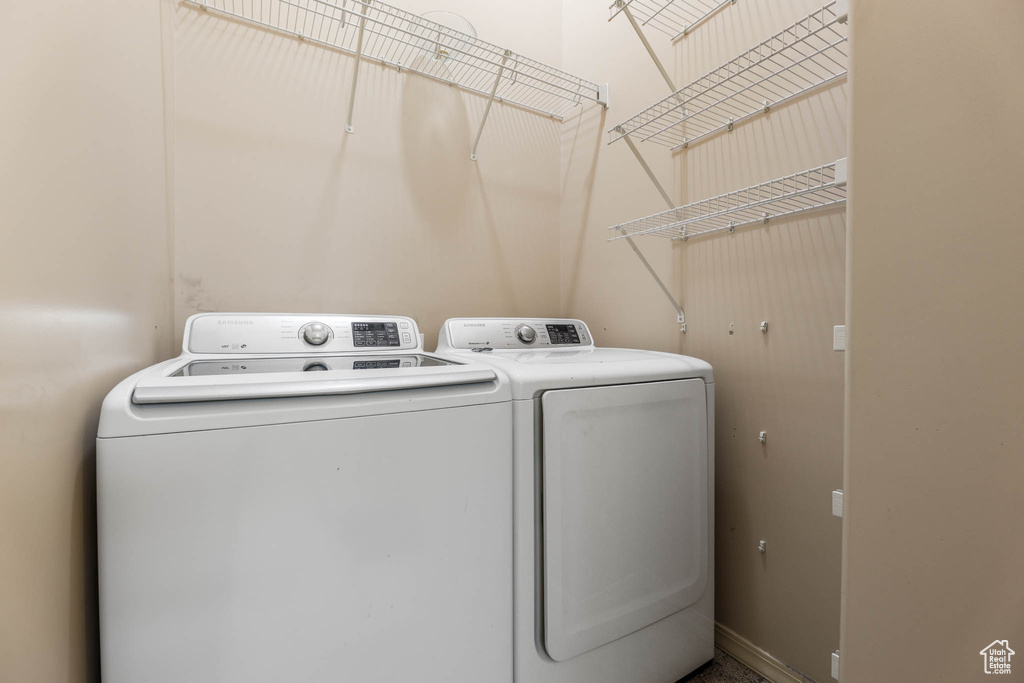 Washroom featuring separate washer and dryer and baseboards