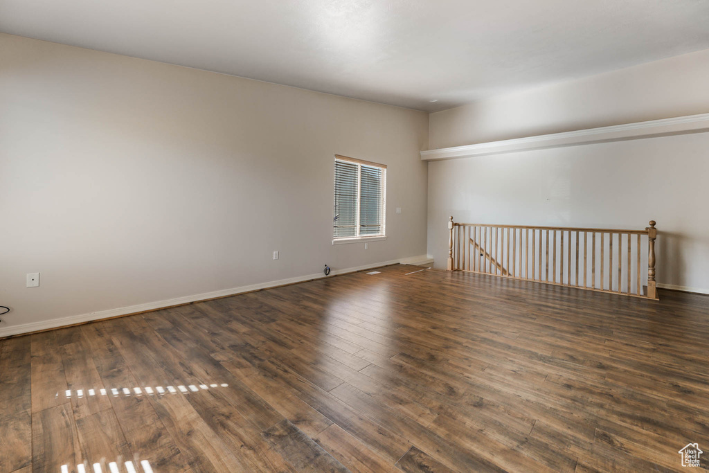 Empty room featuring hardwood / wood-style flooring and baseboards
