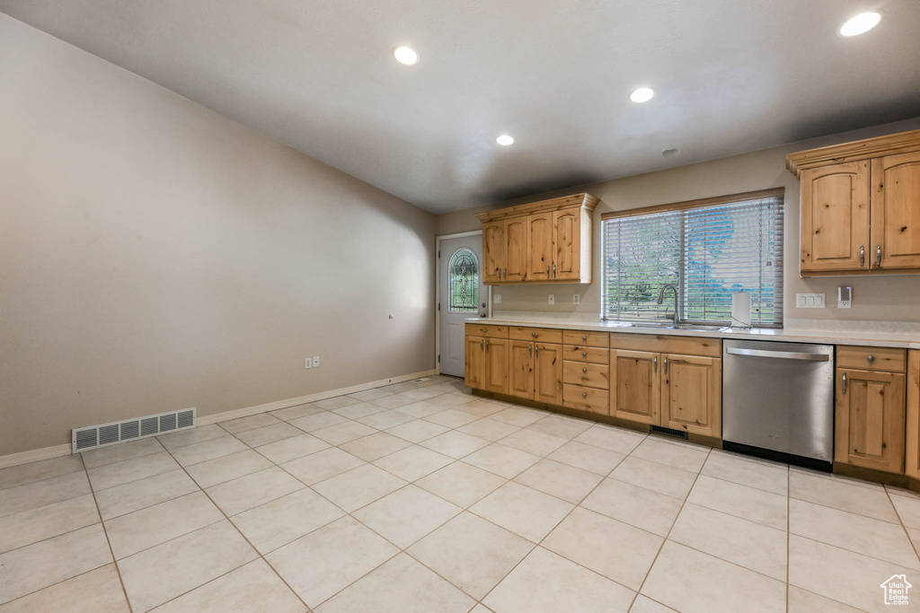 Kitchen with dishwasher, light countertops, recessed lighting, a sink, and baseboards