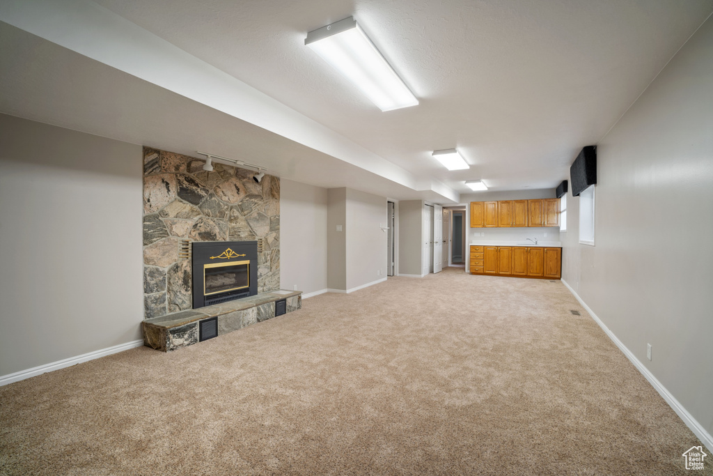 Below grade area with light colored carpet and baseboards