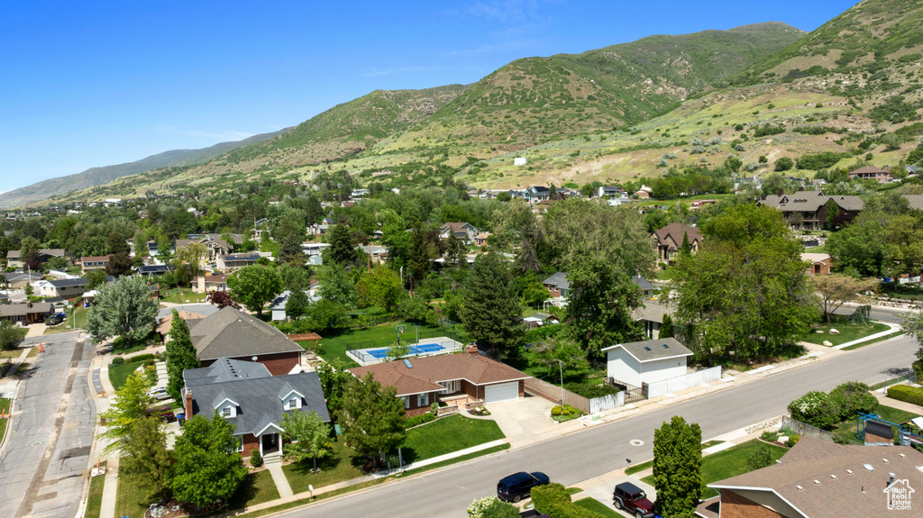 Aerial view of residential area featuring a mountainous background