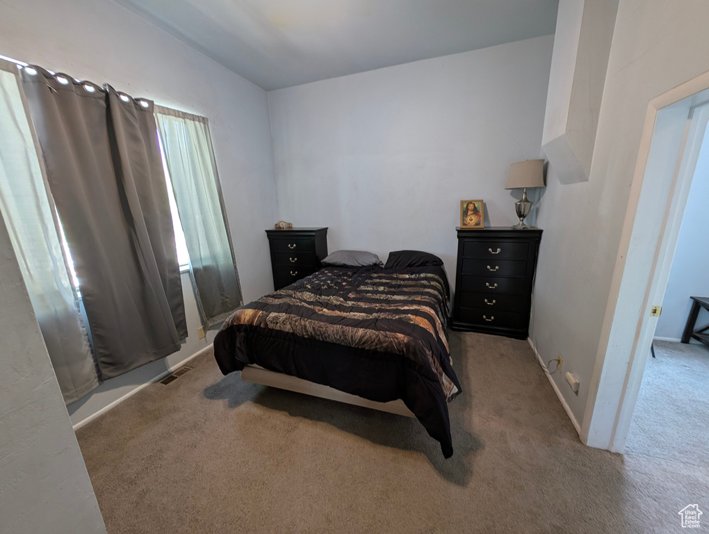 Carpeted bedroom with baseboards