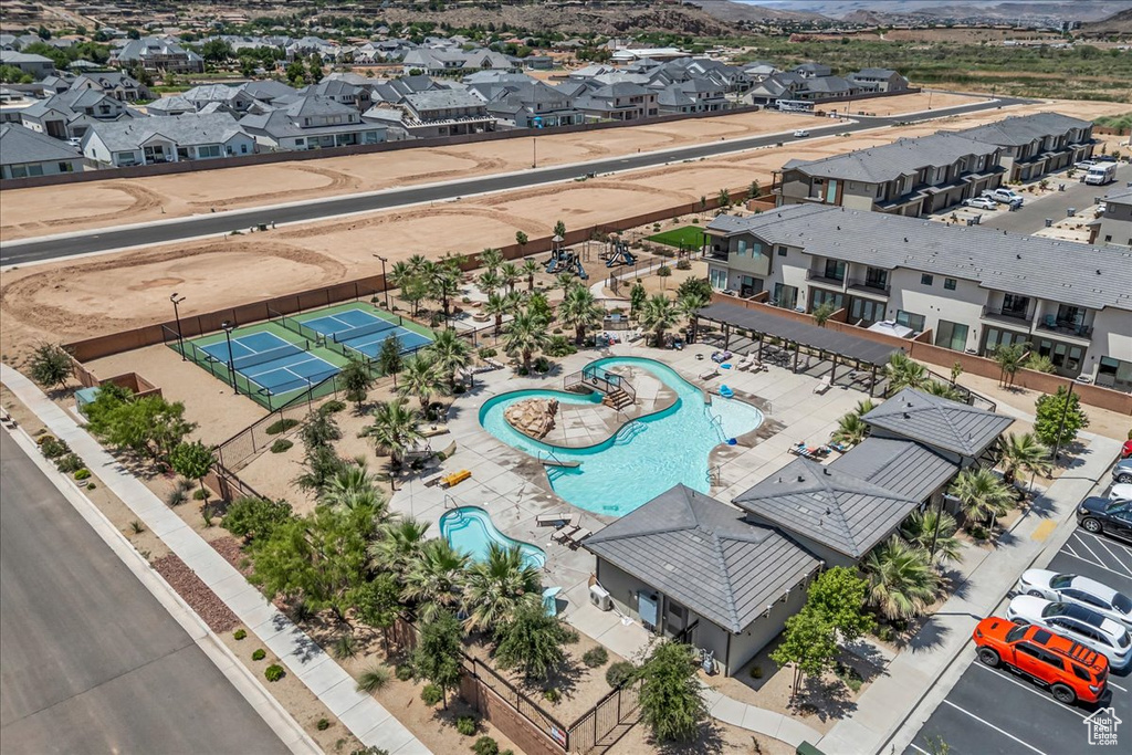 Aerial view of residential area with a pool area and a mountain backdrop