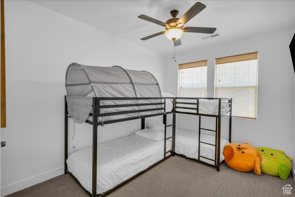 Bedroom featuring carpet, baseboards, and ceiling fan
