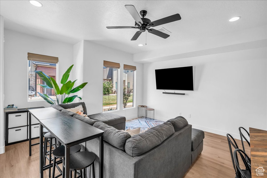 Living room featuring plenty of natural light, recessed lighting, baseboards, and a ceiling fan