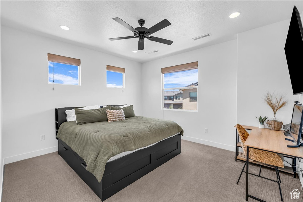 Bedroom with baseboards, recessed lighting, carpet, ceiling fan, and a textured ceiling