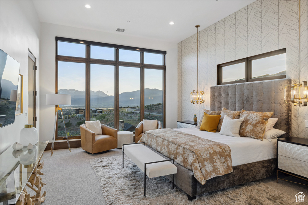 Bedroom with a mountain view, carpet, multiple windows, recessed lighting, and a chandelier