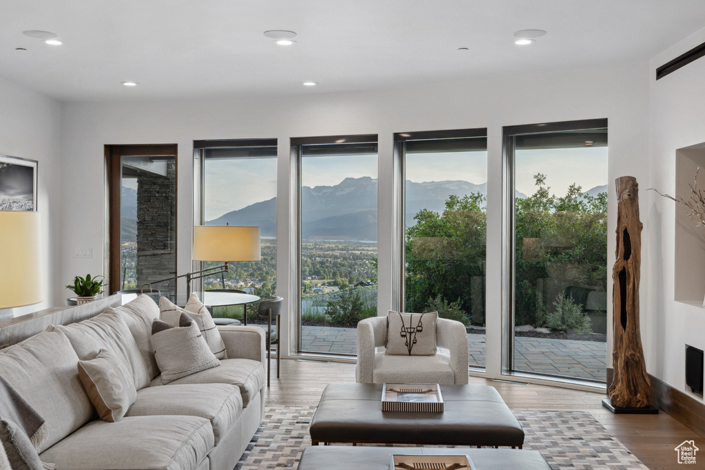 Living area with light wood-style floors, a mountain view, and recessed lighting