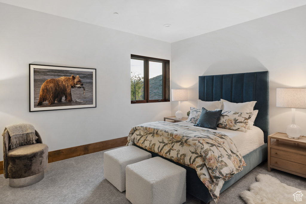 Bedroom featuring carpet and baseboards