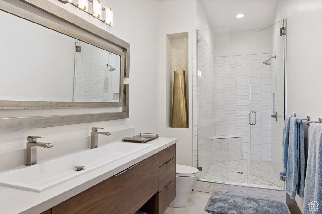 Bathroom featuring vanity, toilet, a shower stall, recessed lighting, and tile patterned flooring