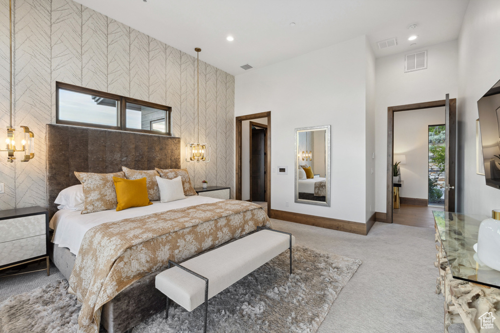 Bedroom featuring carpet flooring, baseboards, recessed lighting, an accent wall, and a towering ceiling