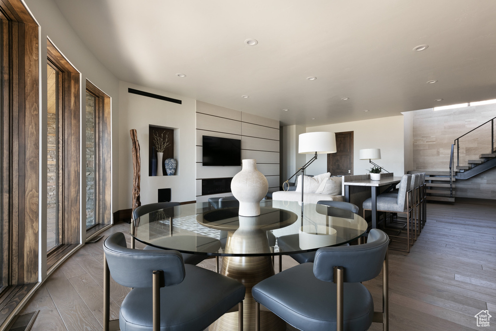 Dining area with stairs, wood-type flooring, and recessed lighting