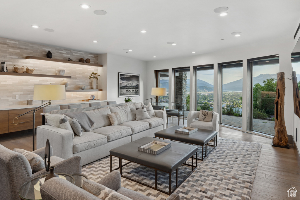 Living area with light wood-style floors and recessed lighting