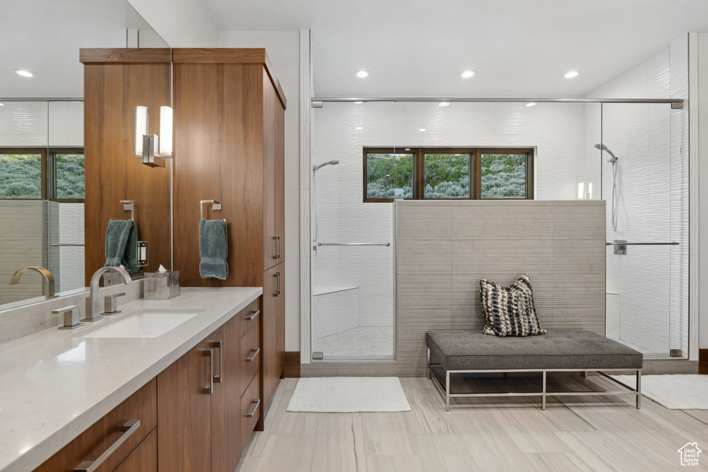 Full bathroom featuring vanity, a stall shower, plenty of natural light, and recessed lighting