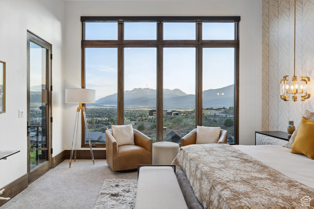 Bedroom with a mountain view, a chandelier, multiple windows, and baseboards