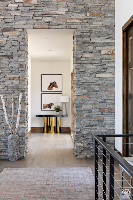 Corridor featuring an upstairs landing and baseboards