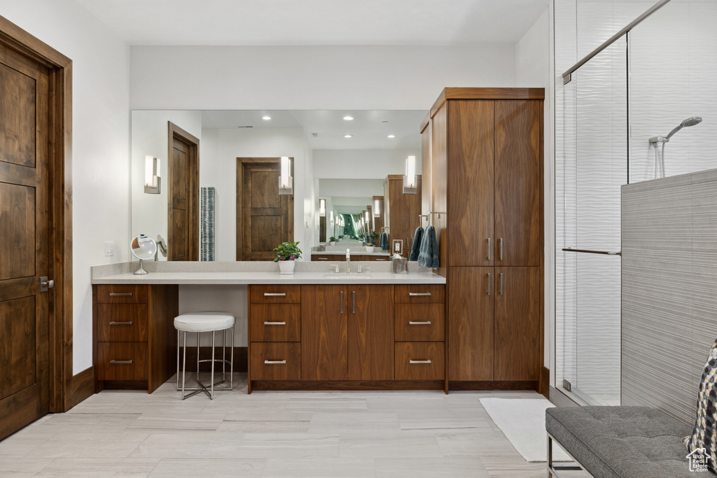 Full bath featuring vanity and a shower stall