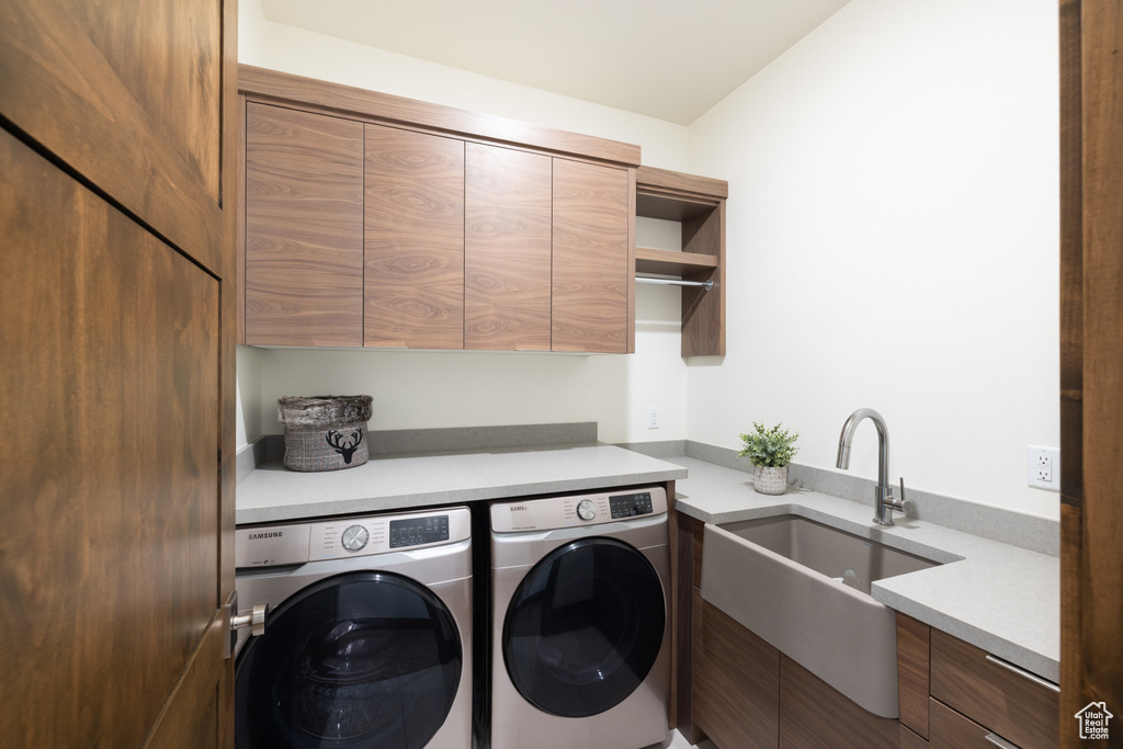Laundry area featuring cabinet space and washing machine and dryer