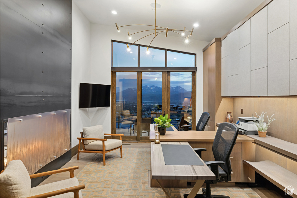 Office area featuring a wall of windows, a chandelier, and recessed lighting