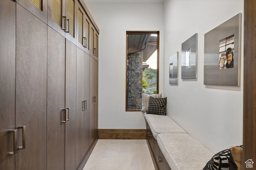 Mudroom featuring light tile patterned floors and baseboards
