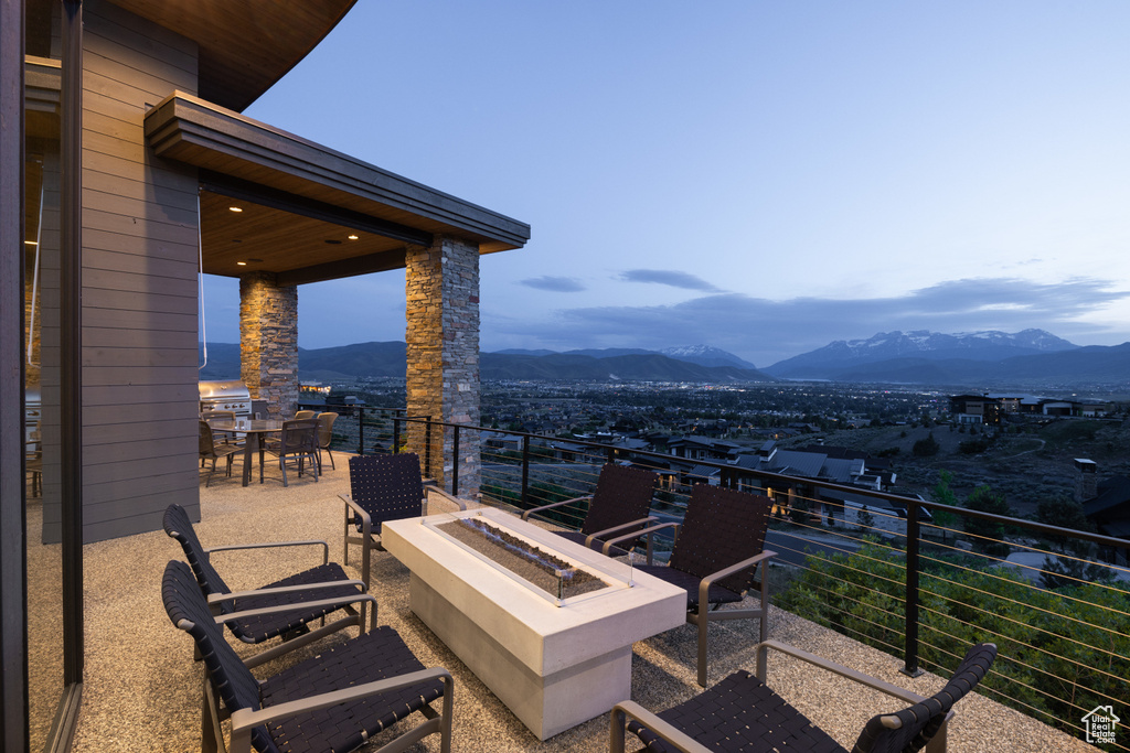 View of patio / terrace with an outdoor fire pit, a mountain view, and outdoor dining area