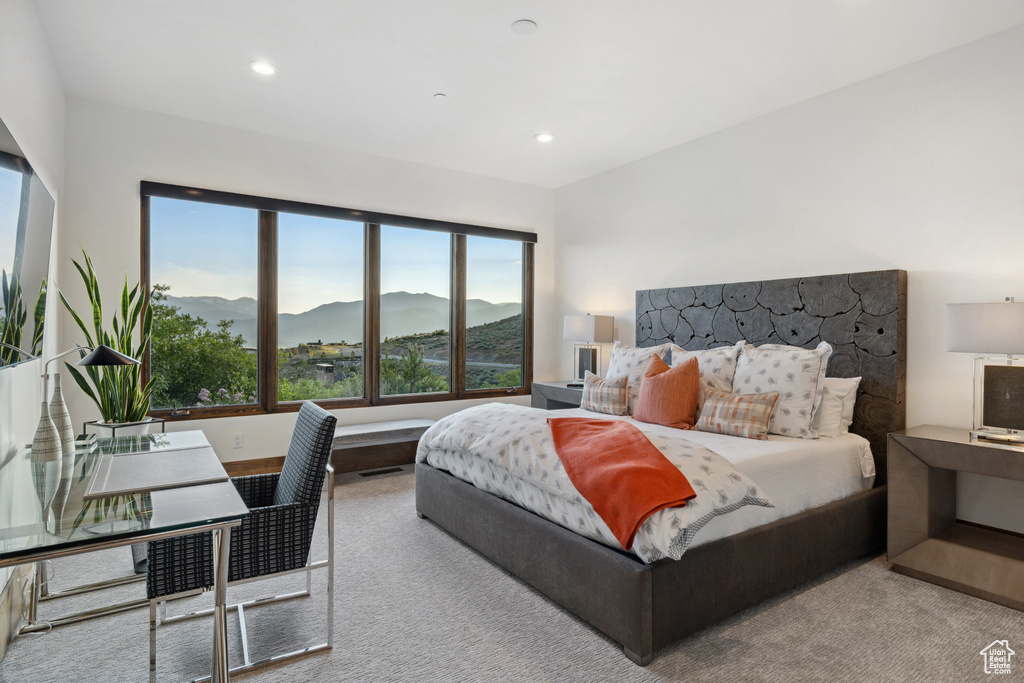 Bedroom featuring a mountain view, carpet flooring, multiple windows, and recessed lighting