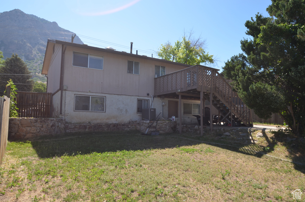 Rear view of property with stairs, a deck, and cooling unit