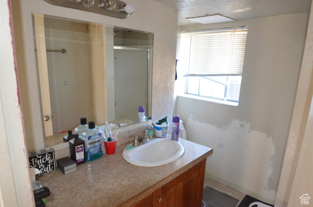 Full bathroom featuring vanity and a stall shower
