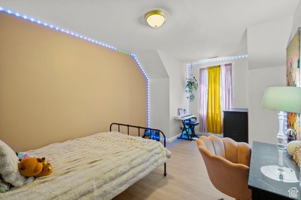 Bedroom featuring wood finished floors and baseboards