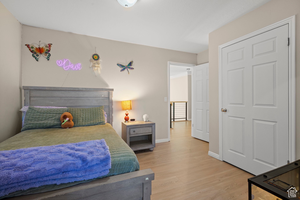 Bedroom featuring light wood-style floors and baseboards