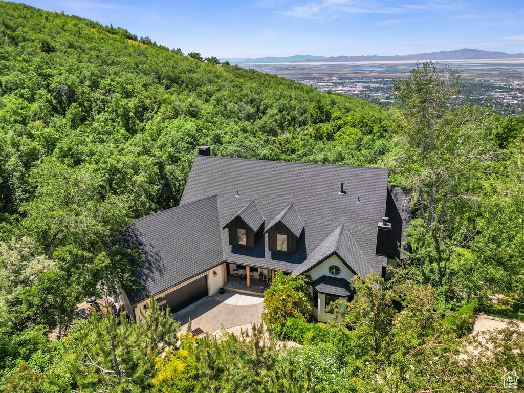 View of subject property with a forest and a mountainous background