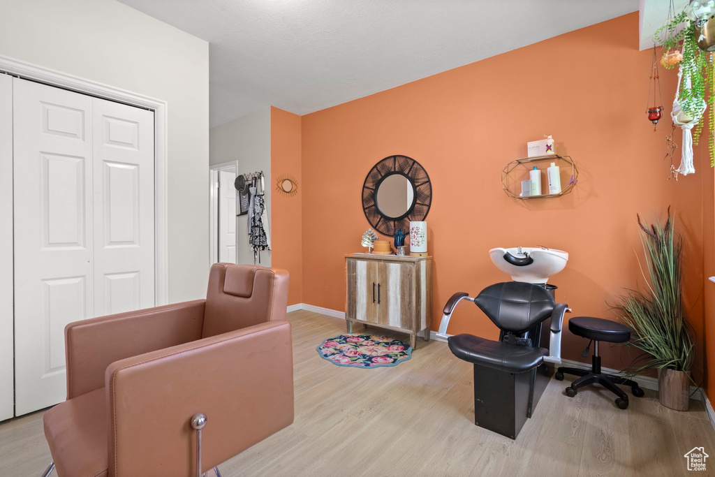 Sitting room with wood finished floors and baseboards