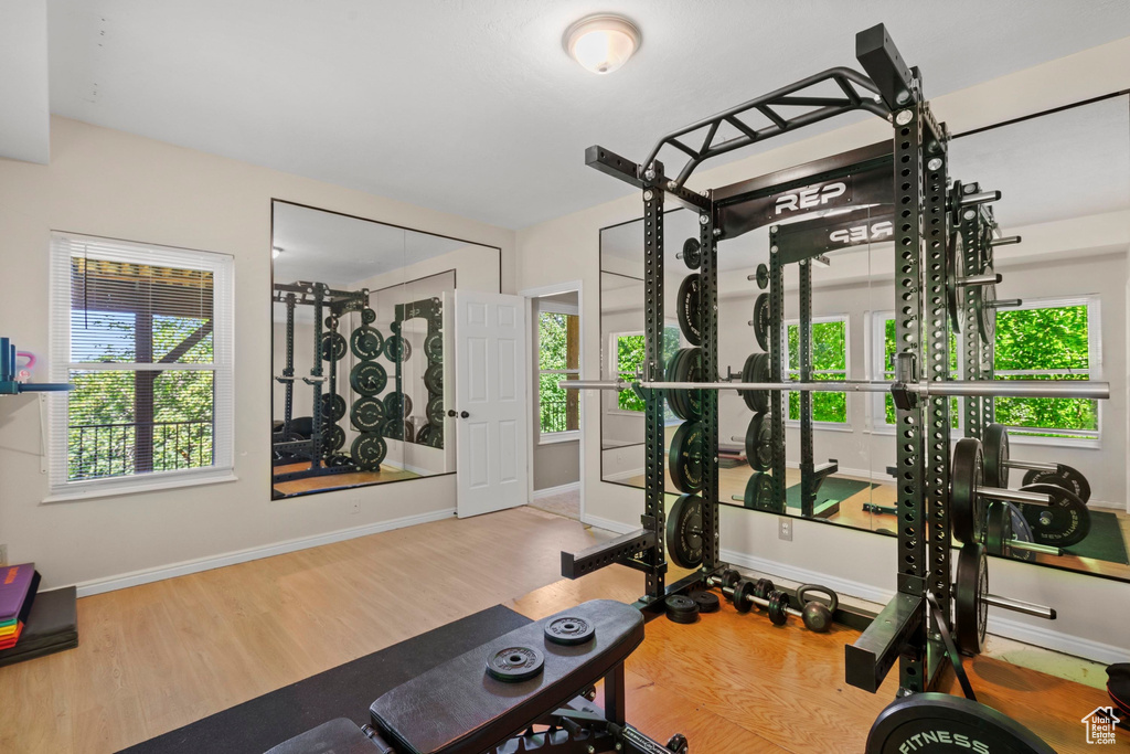 Workout room with wood finished floors and baseboards