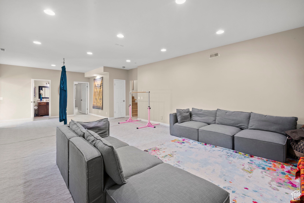 Living room featuring recessed lighting, light carpet, and baseboards