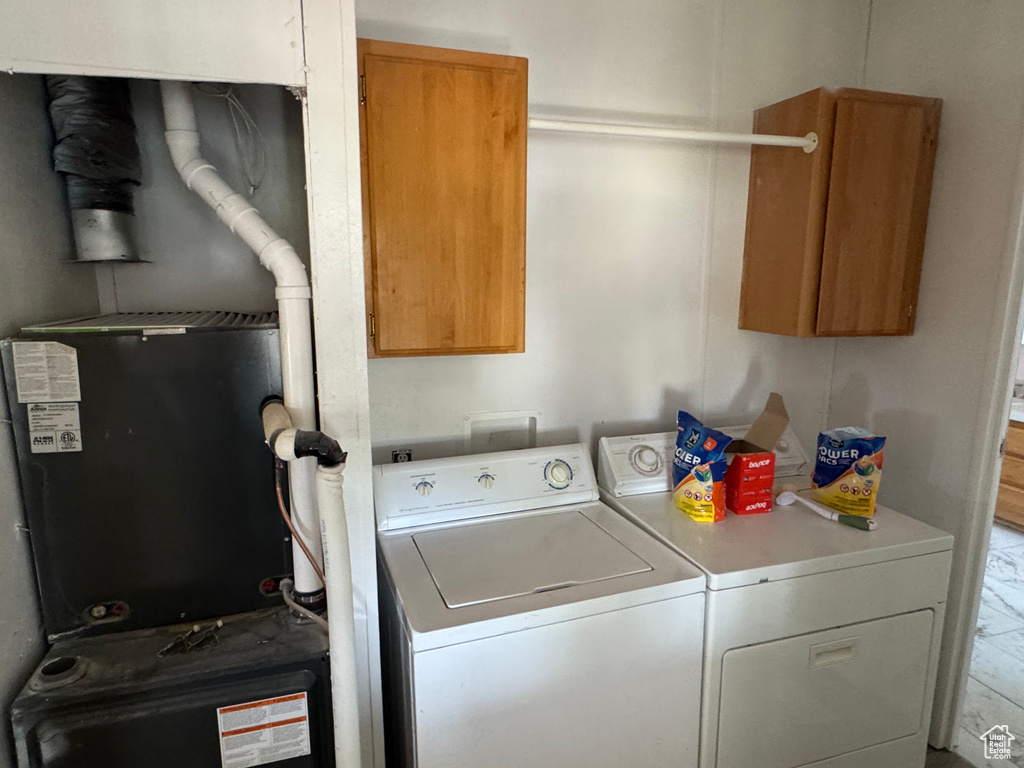 Laundry area with washer and clothes dryer and cabinet space