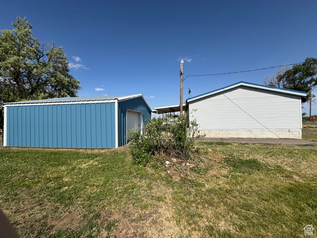 View of green lawn with an outbuilding