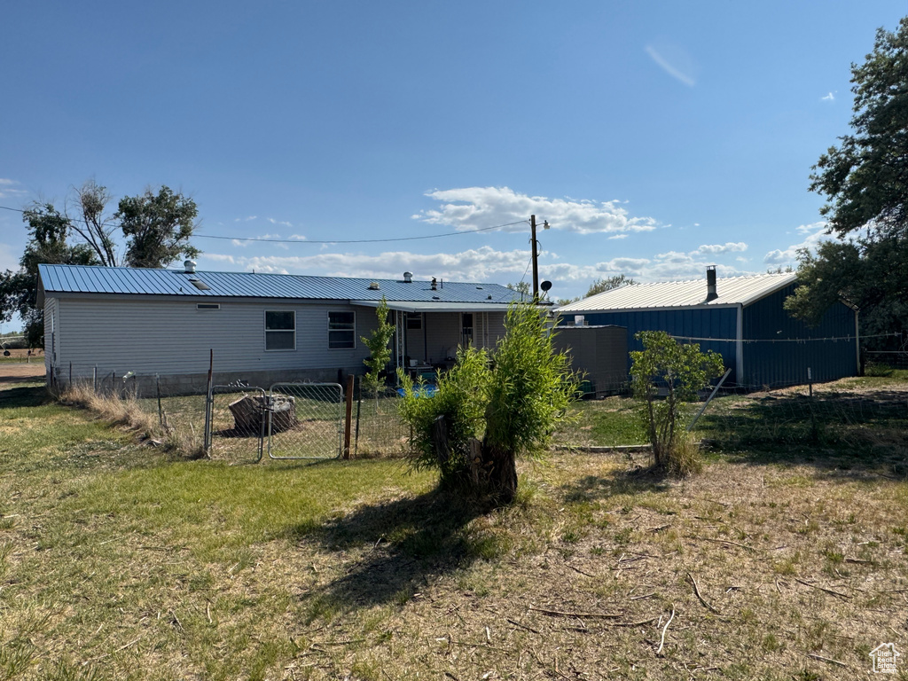 Rear view of property featuring metal roof