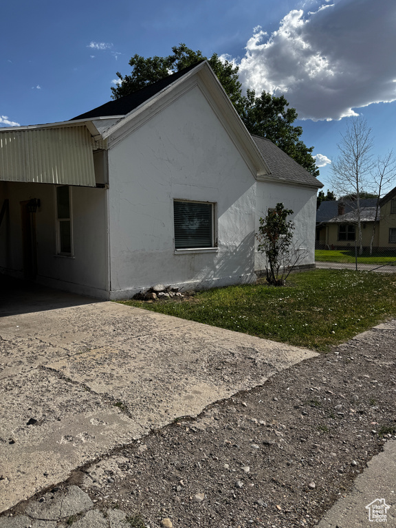 View of side of home featuring driveway