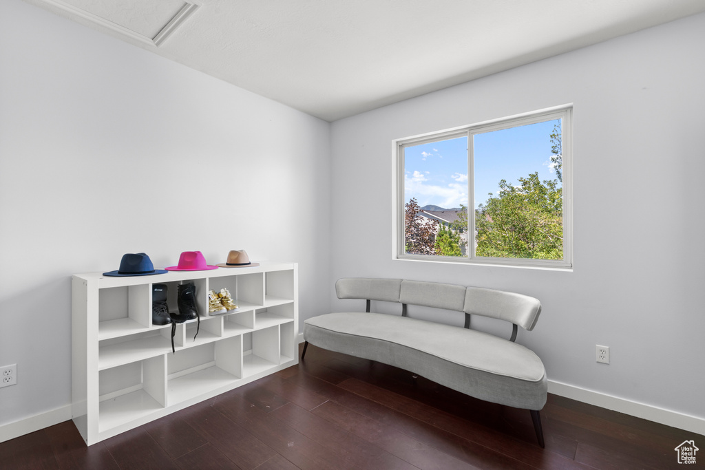 Living area with baseboards and wood finished floors