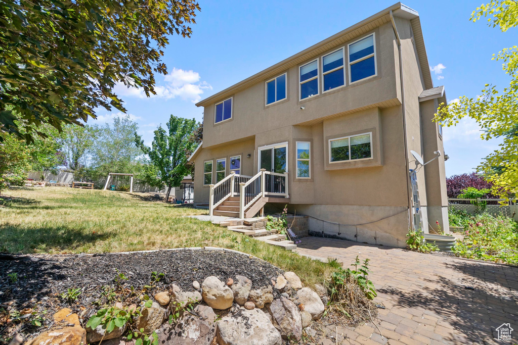 Back of house featuring stucco siding