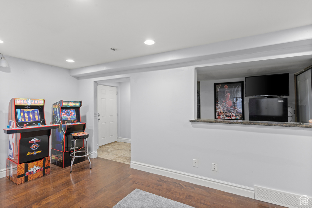 Game room with baseboards, recessed lighting, and wood finished floors