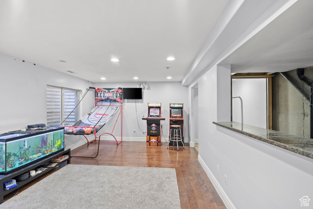 Rec room with recessed lighting, wood finished floors, and baseboards