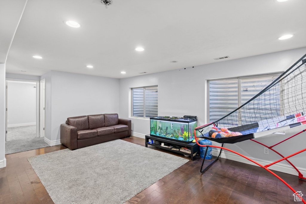 Living room with hardwood / wood-style flooring, baseboards, and recessed lighting