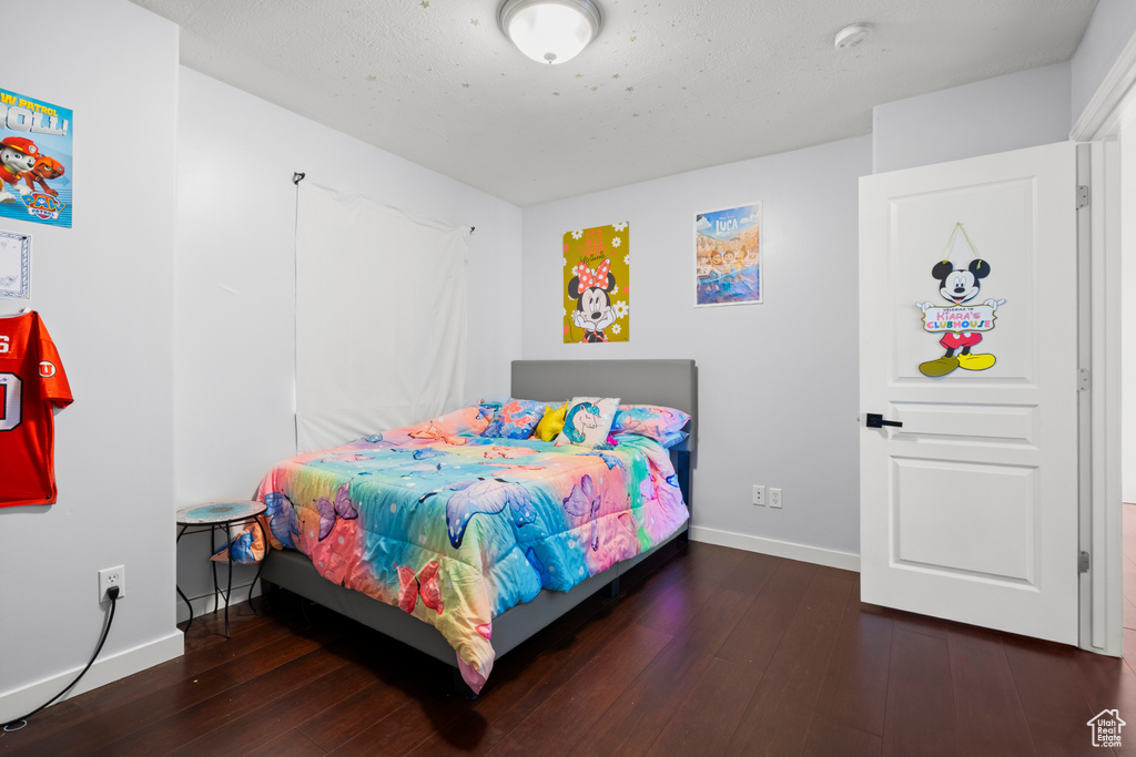 Bedroom featuring baseboards and hardwood / wood-style flooring