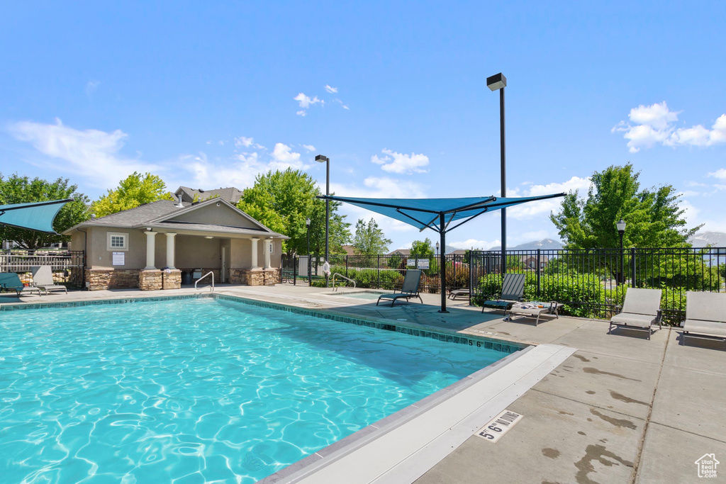 Community pool with a patio