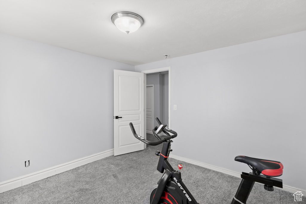Exercise area featuring carpet floors and baseboards