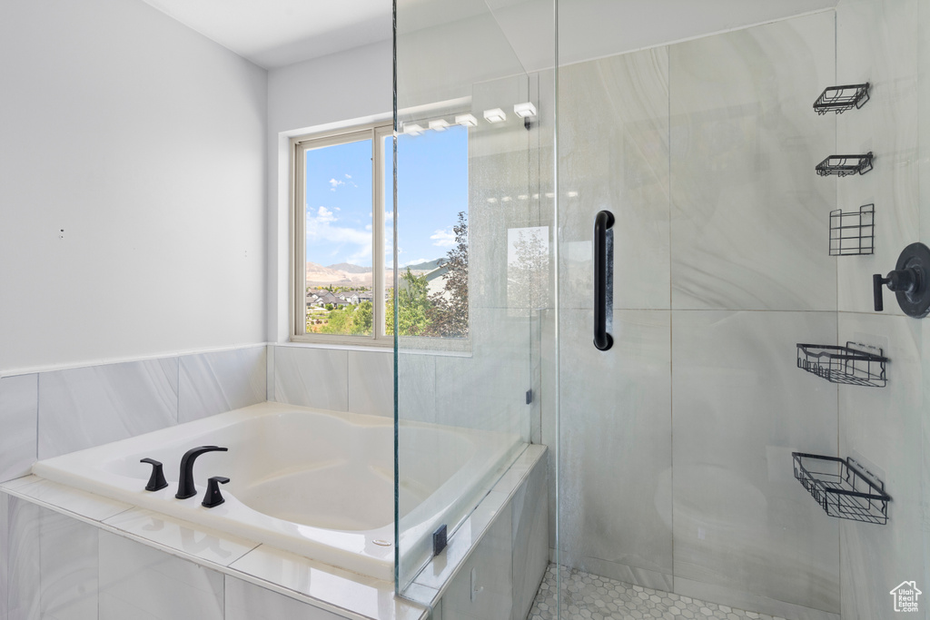 Full bath featuring a bath and a shower stall