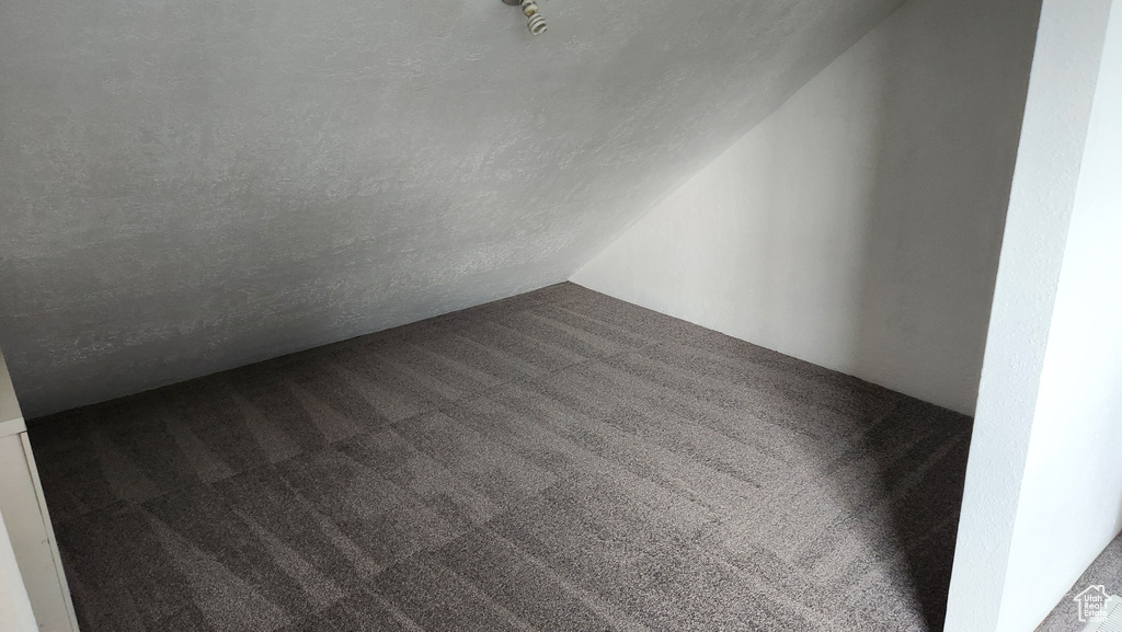 Spare room featuring a textured ceiling and carpet